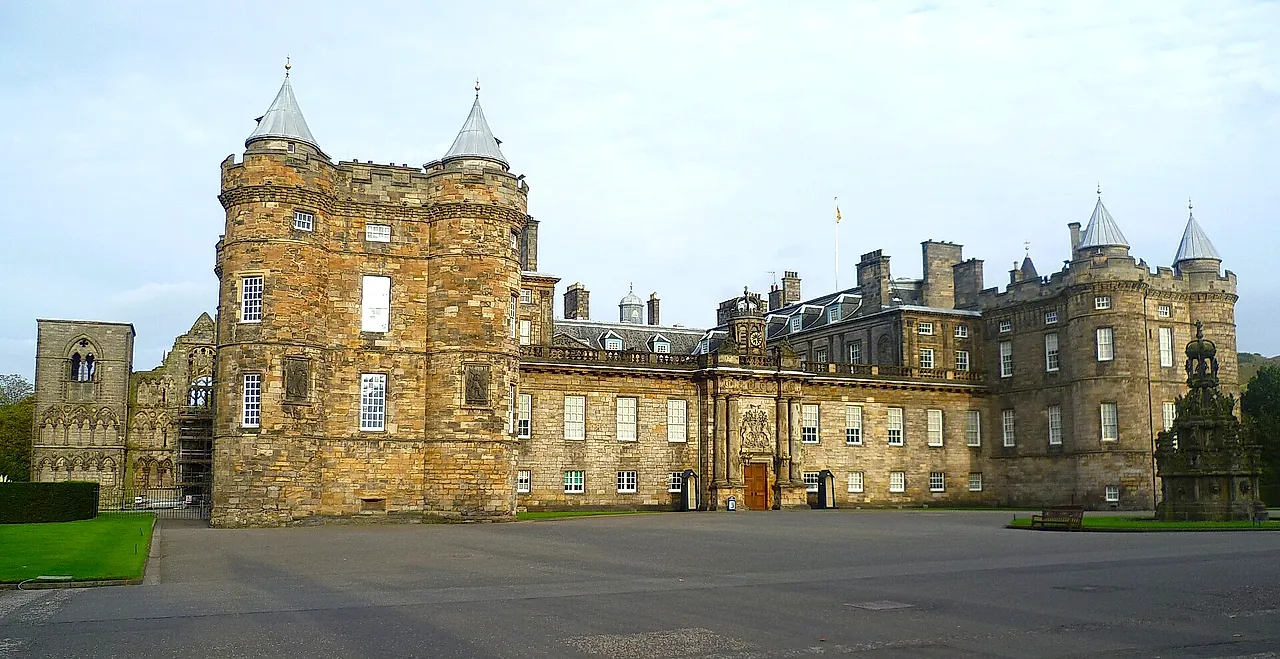The Palace of Holyroodhouse: the sandstone front with its two towers topped by conical turrets, seen across the forecourt